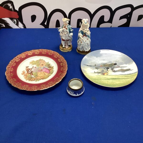 Vintage porcelain plates with floral designs, part of a decorative collection.