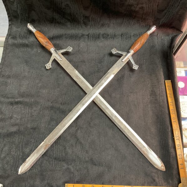 Antique decorative wall swords displayed as a pair.