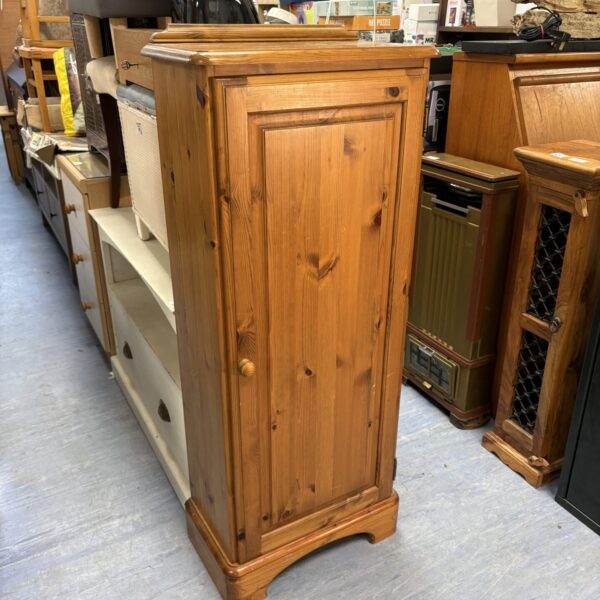 Vintage Ducal pine cupboard with a panelled door, ideal for farmhouse style interiors.