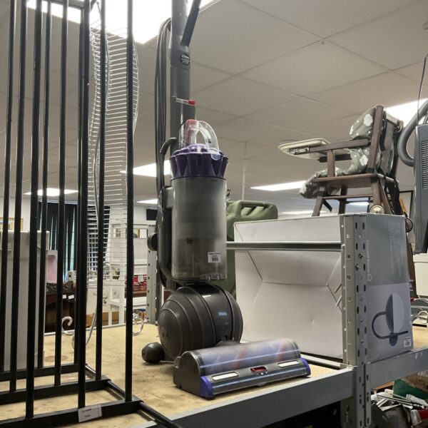 Used Dyson DC77 upright vacuum cleaner for home cleaning.