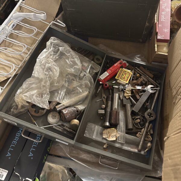 Metal drawers filled with a diverse lot of engineering tools and parts.