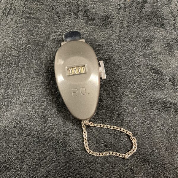 Vintage Enm post office tally counter with dial visible.