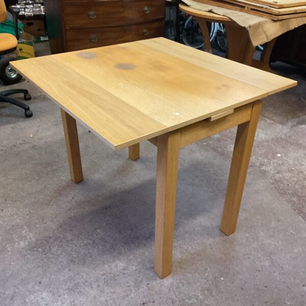 Solid wood extending dining table in farmhouse style.