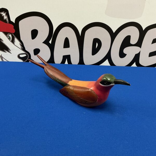 Detailed side view of a hand-carved bird figurine by Feather’s Gallery.