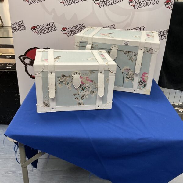 Vintage floral storage chest with a charming patterned fabric.