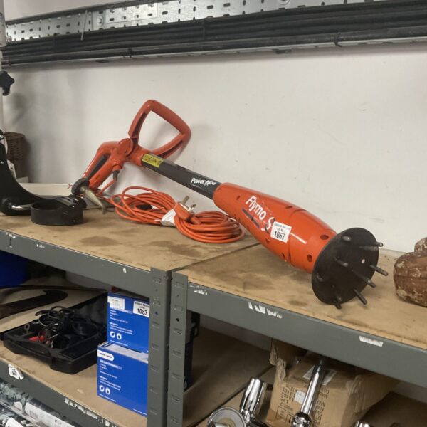 Orange and black Flymo power hoe, model 1067, for garden cultivation.