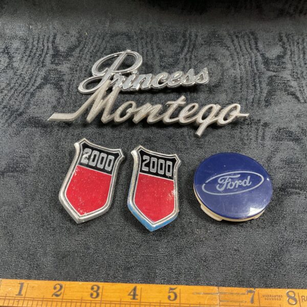 Pair of vintage Ford 2000 badges for classic car restoration.