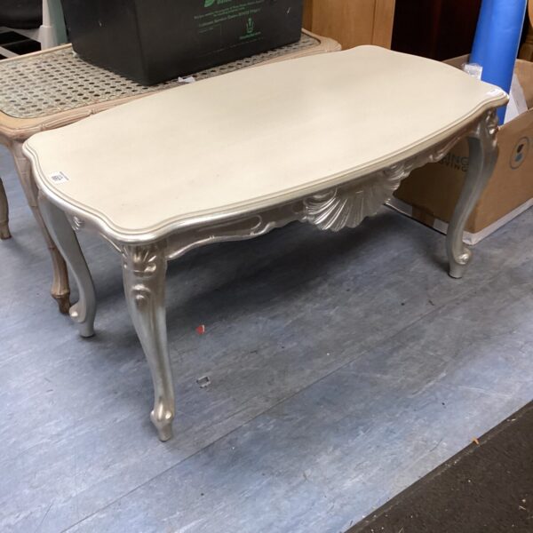 Ornate French style coffee table with carved legs.