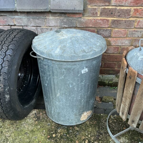Weathered vintage galvanised garden bin with rustic charm.