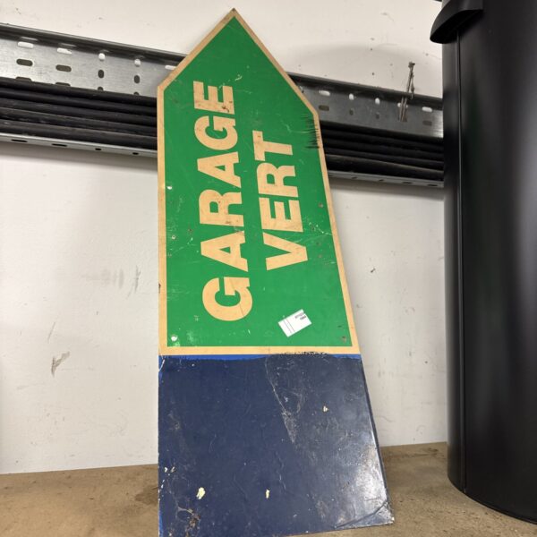 Vintage acrylic garage arrow sign for directional purposes.
