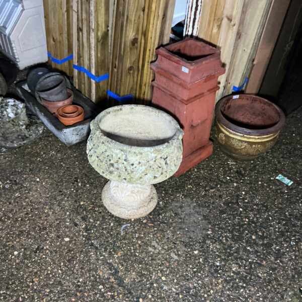 Stone effect garden planter displayed outdoors, ideal for plants.