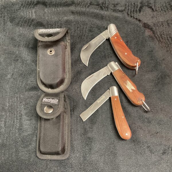 Set of three vintage garden pruning knives with sheaths.