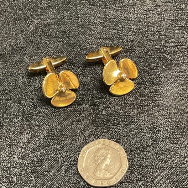 Vintage gilt propeller cufflinks for men's formal wear.