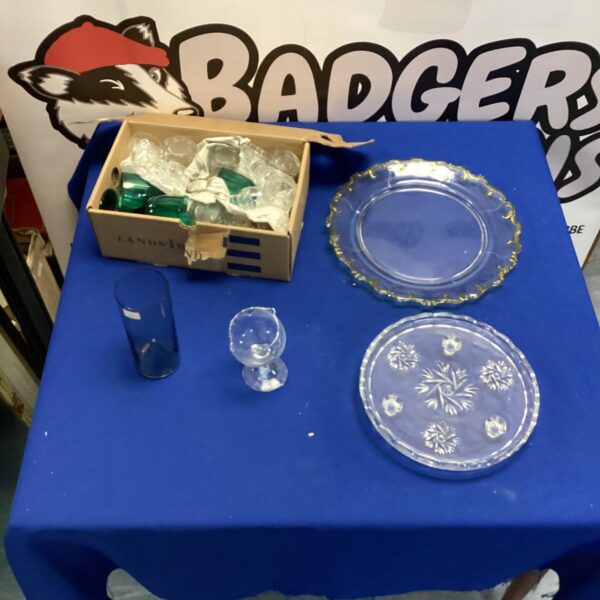 Vintage glass serving dishes and assorted glasses on display.