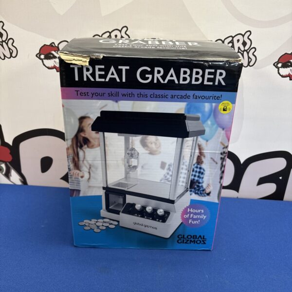 Global Gizmoz treat grabber arcade machine with joystick control.