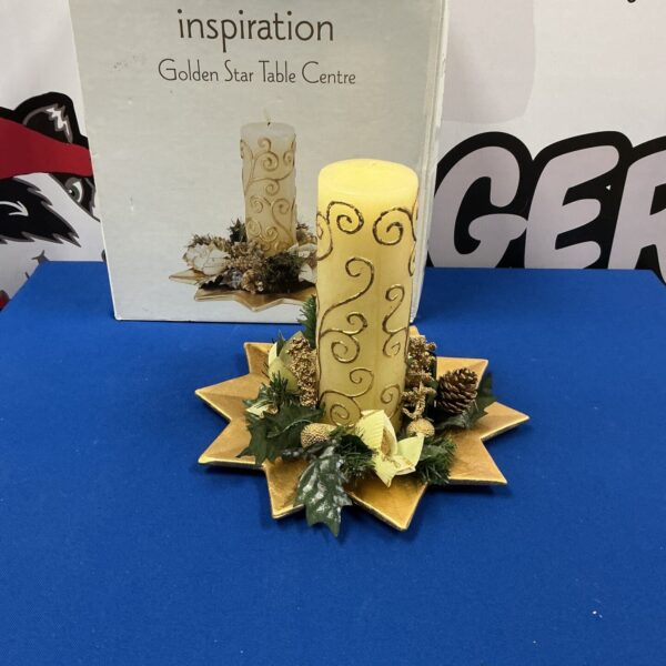 Golden star table centre with festive decorations for Christmas.