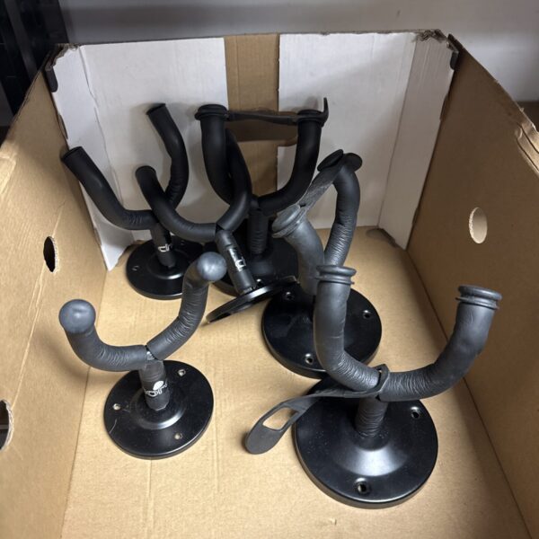 Lot of six black guitar wall mount hooks for instrument storage.