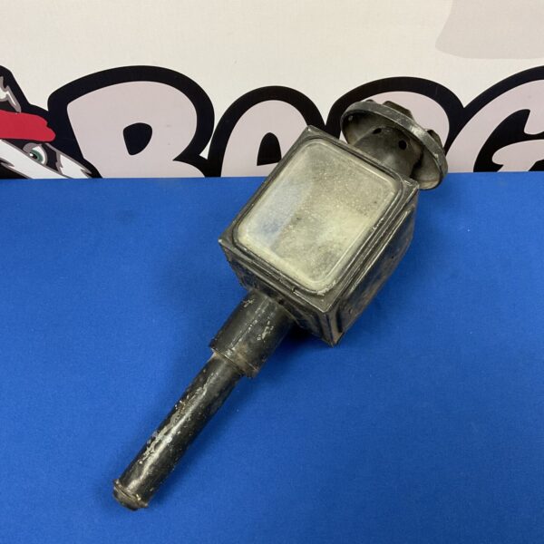 Antique Hackney carriage lantern with red lens, side view.