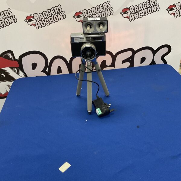 Vintage Halina 2000 camera with tripod for film photography.