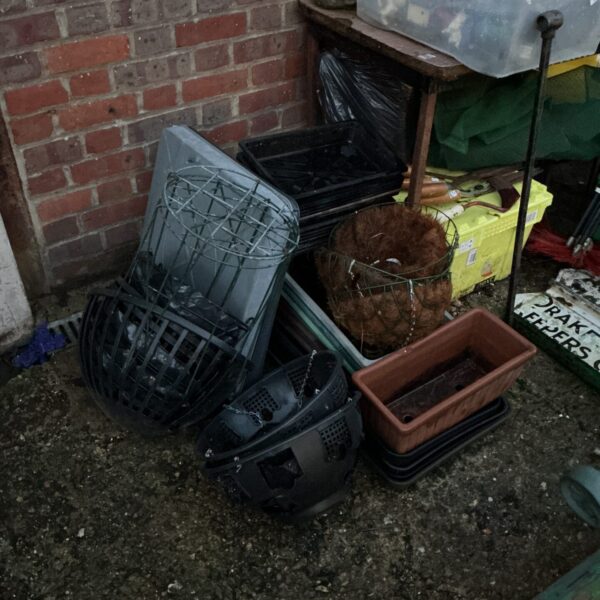Mixed lot of hanging baskets and planters for garden use.