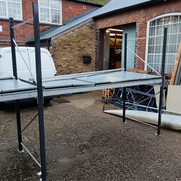 Side view of heavy-duty metal racking system with shelving.