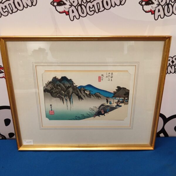 Vintage Hiroshige Japanese woodblock print of a mountain landscape with figures.