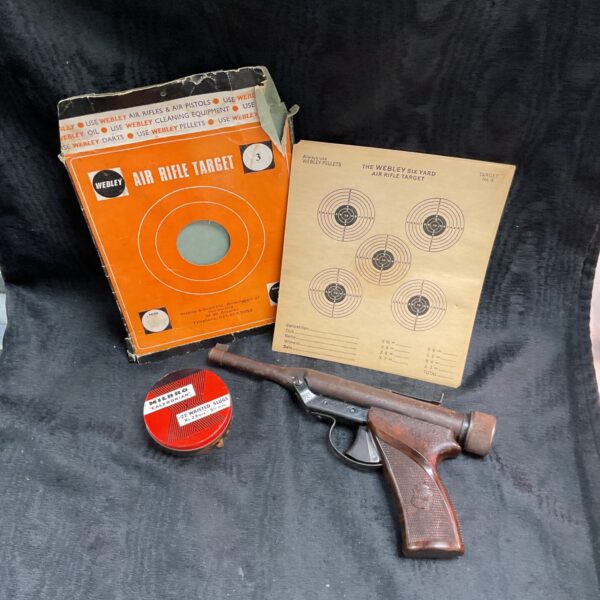 Vintage Hy-Score air pistol with original targets and .22 pellets.