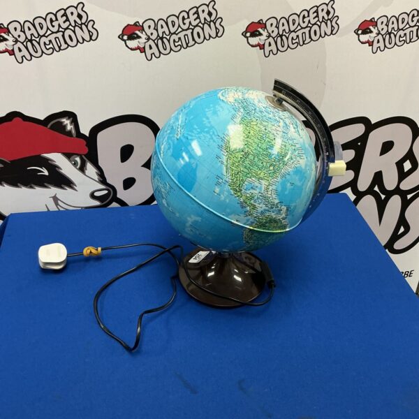 Illuminated world globe lamp on a stand, detailed geographical features.