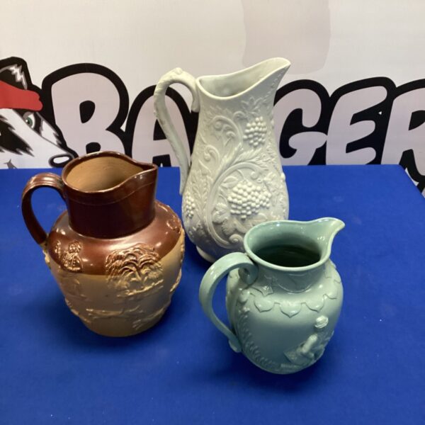 Three studio pottery style jugs, including Portmeirion