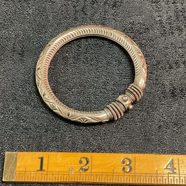 Antique Indian silver torque bracelet with intricate detailing.