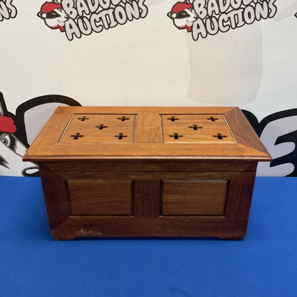 Small Indian wooden chest with a hinged lid, ideal for storage.