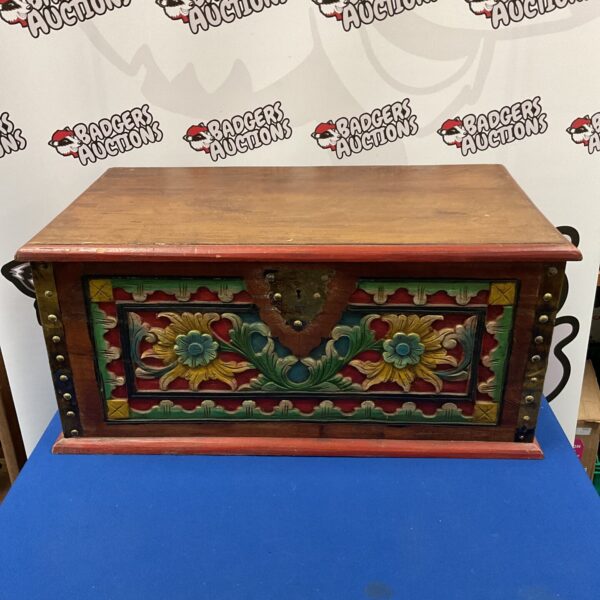 Antique Indonesian wedding chest with vibrant floral carvings.