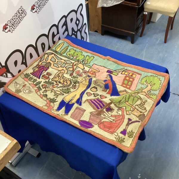 Vibrant mid-century Iraqi embroidery panel depicting a lively scene.