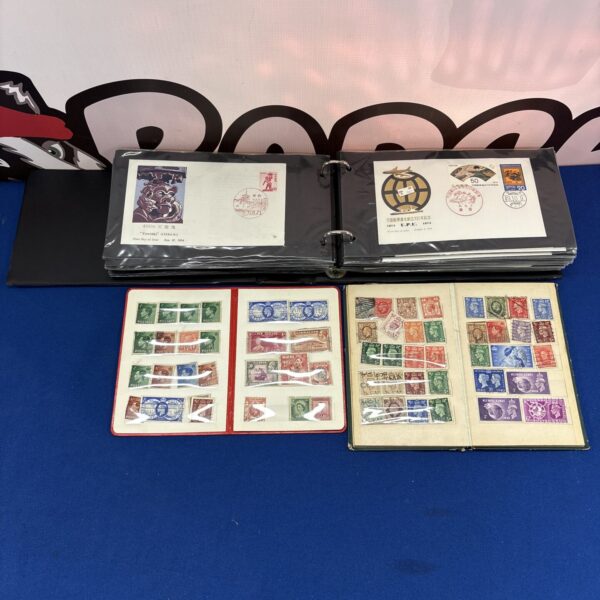 Vintage Japanese first day covers and British stamp books in a binder.