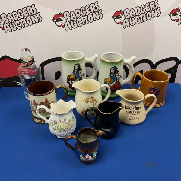 Vintage collection of ceramic jugs and tankards, including Isle of Jura branding.