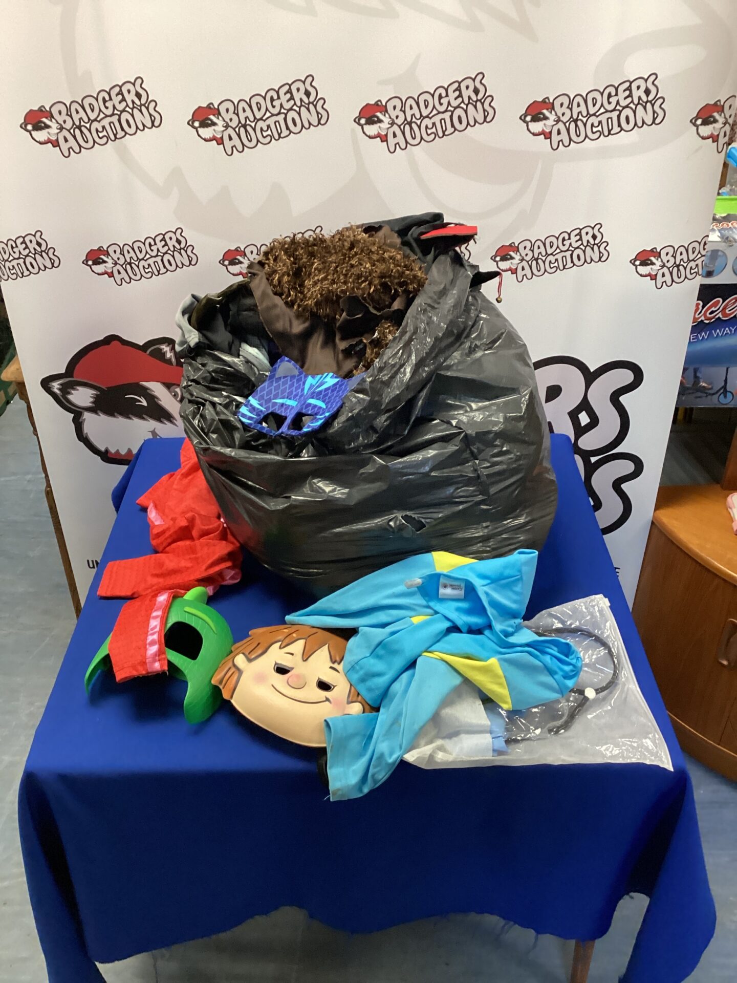 Mixed lot of kids fancy dress costumes including Batman and PJ Masks.