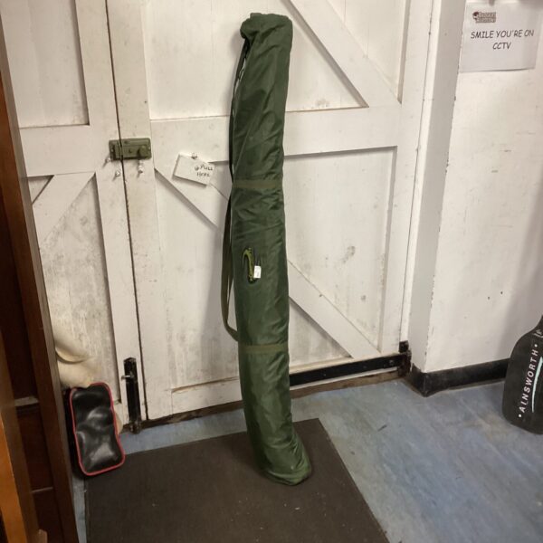 Korum fishing shelter with front opening, ready for angling.