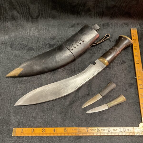 Vintage military Kukri knife with wooden handle and scabbard.