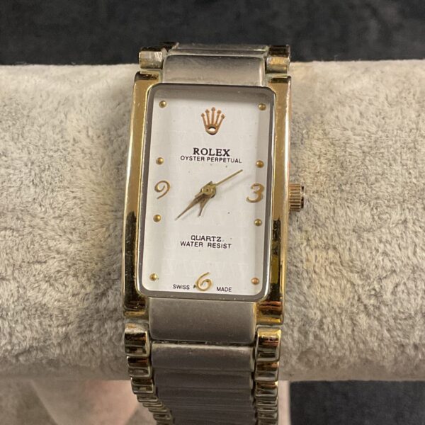 Gold-tone ladies quartz wristwatch with stainless steel band.