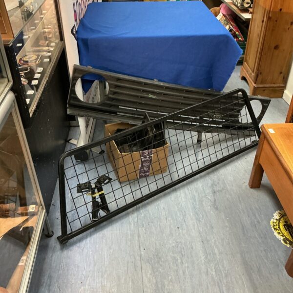Vintage Land Rover front grill with mesh and dog grate section.