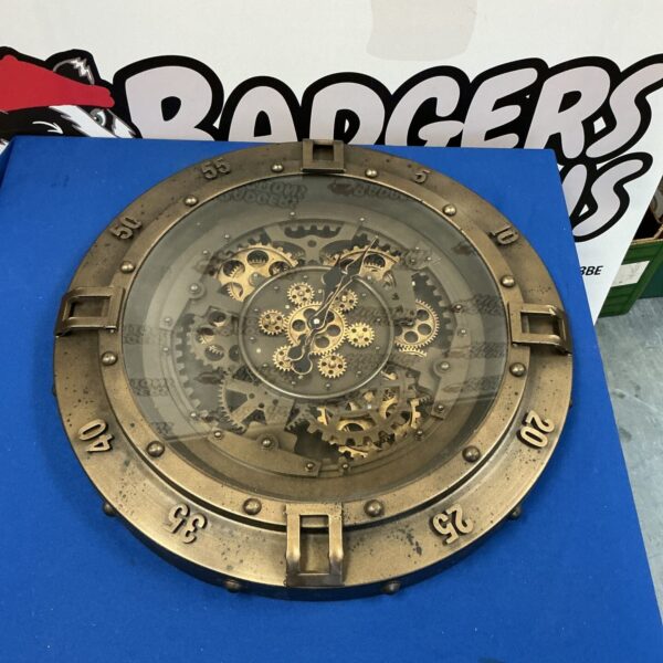 Intricate large cog clock mechanism with exposed gears.