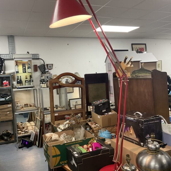 Large red Anglepoise lamp with articulated arm and conical shade.