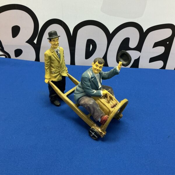 Vintage Laurel and Hardy figurine depicting a classic comedy scene.