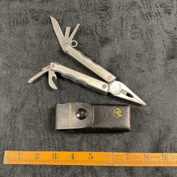 Leatherman multitool with leather belt pouch, a versatile pocket tool.