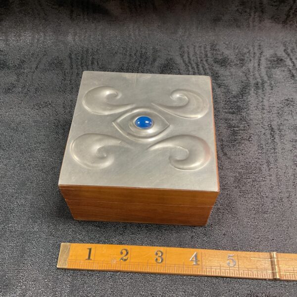 Front view of a Liberty pewter trinket box with turquoise lid.