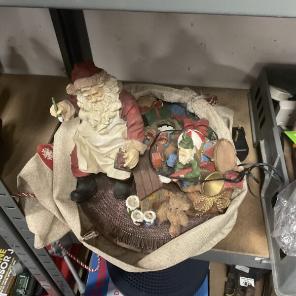 Detailed light-up Santa ornament in a Christmas canvas sack.