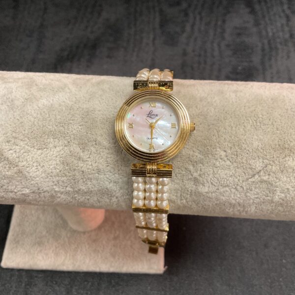 Elegant Lotus Quartz ladies watch with faux pearl strap.