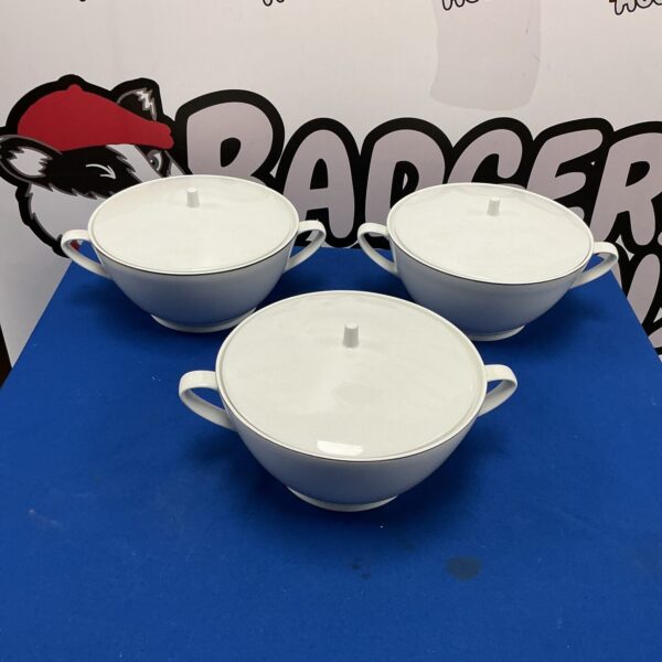 Three white LSA serving dishes on a dark surface.