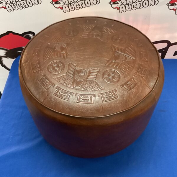 Intricately carved Mayan leather pouf for bohemian decor.