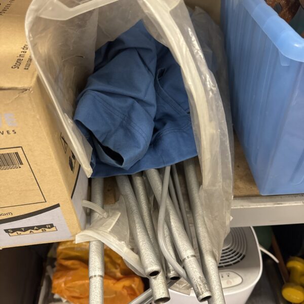 Vintage metal camp bed frame for camping or guest use.